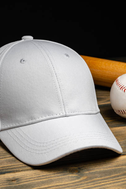 istock Baseball cap, ball and bat on wooden background 2153179753