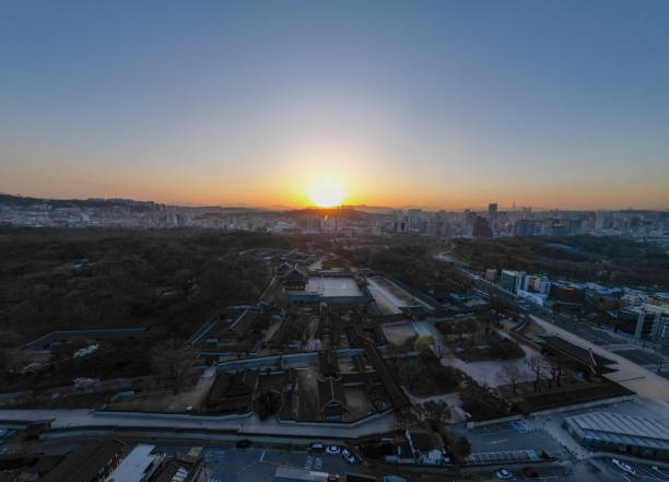 Changdeokgung Palace, located in Seoul, Korea, is a palace from the Joseon Dynasty. This is a video clip taken with a drone outside Changdeokgung Palace to show the sunrise in the morning. It is uploaded as the original without color correction.