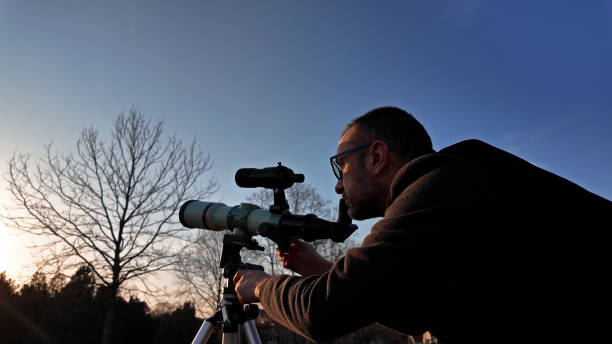 istock Amateur astronomer observing Sun eclipse and Sun with a telescope and special solar filter. 2153181692