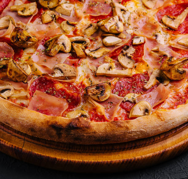 pizza with ham, salami and mushrooms