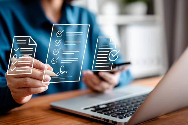 istock Businesswomen using a stylus pen to sign one document on a virtual notebook screen, E-signing, electronic signature, document management, and paperless office concept. 2153183419