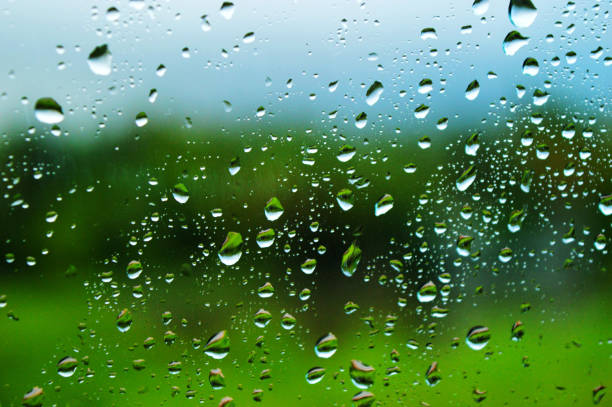 A small raindrop rests on the glass after rain.