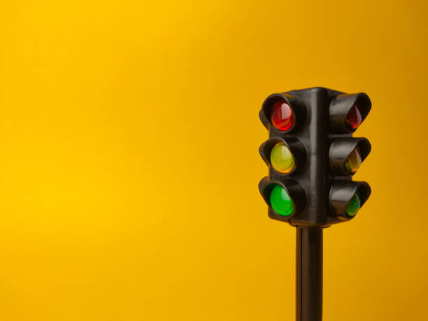 istock Mini traffic lights on a yellow background 2153183933