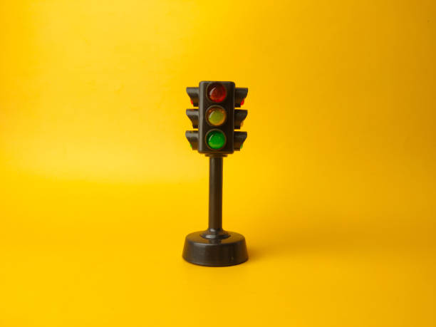 istock Mini traffic lights on a yellow background 2153183934