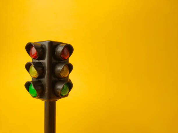 istock Mini traffic lights on a yellow background 2153183935