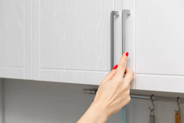 istock housewife opens kitchen wall cabinet, close-up. 2153187507