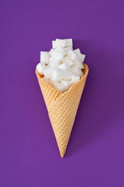 istock Ice cream cone with sugar cubes on purple background. Food concept. Minimal summer creative idea. Flat lay. 2153188892
