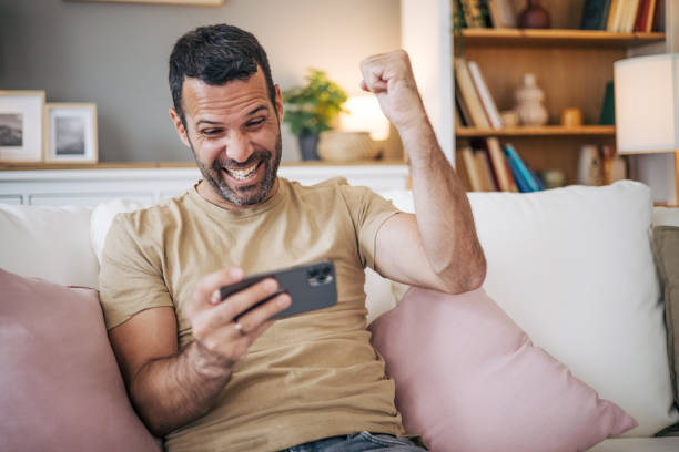 istock Mature man playing video games on his phone 2153189226