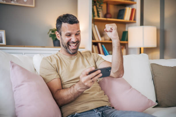 istock Mature man playing video games on his phone 2153189287