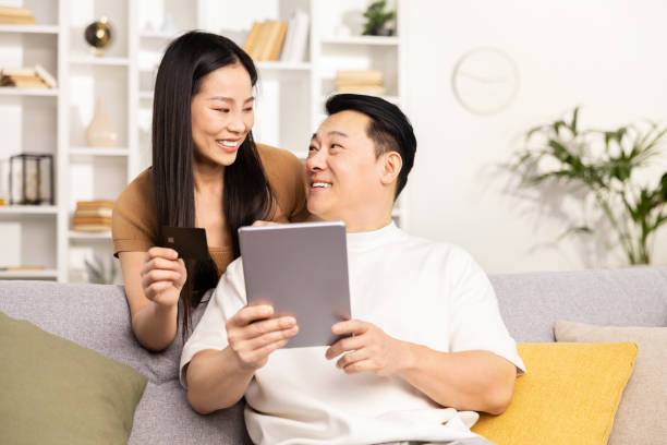 istock Couple Shopping Online Together on a Comfortable Sofa 2153190733