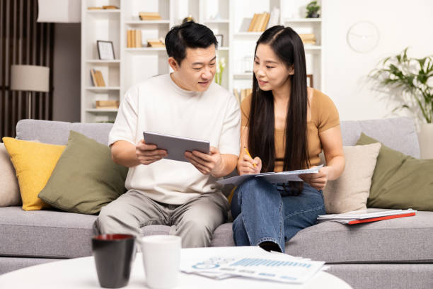 istock Couple Discussing Finances With Tablet And Documents At Home 2153190745