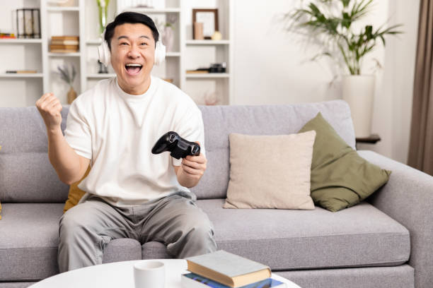 istock Joyful Man Winning at Video Games on Couch at Home 2153190792