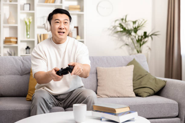 istock Enthusiastic Man Playing Video Game in Living Room 2153190812