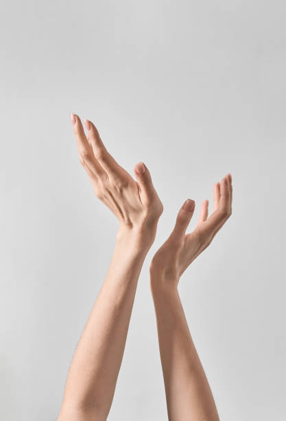 istock Two Hands Reaching Up Into the Air 2153192822