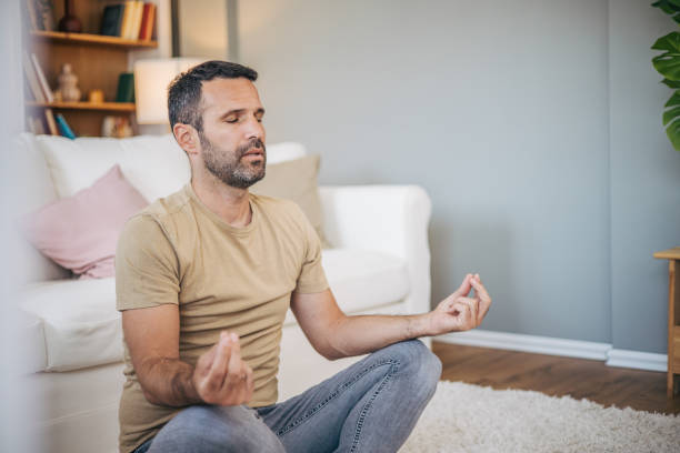 istock A man practices yoga at home 2153193522