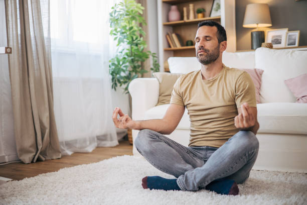 istock A man practices yoga at home 2153193548