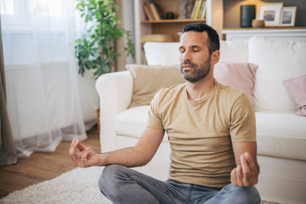istock A man practices yoga at home 2153193549