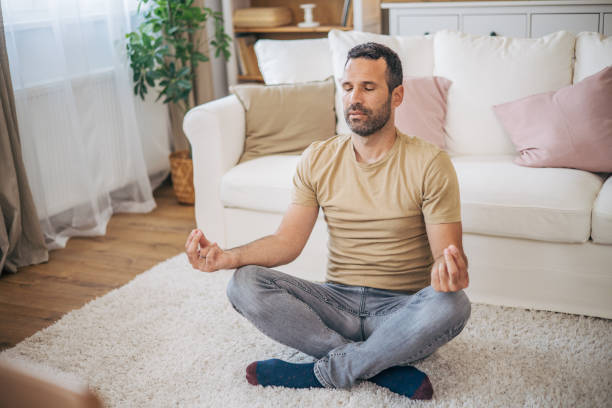 istock A man practices yoga at home 2153193643