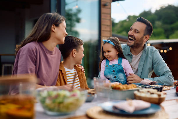 istock Happy family talking while enjoying in lunch on a patio. 2153193771
