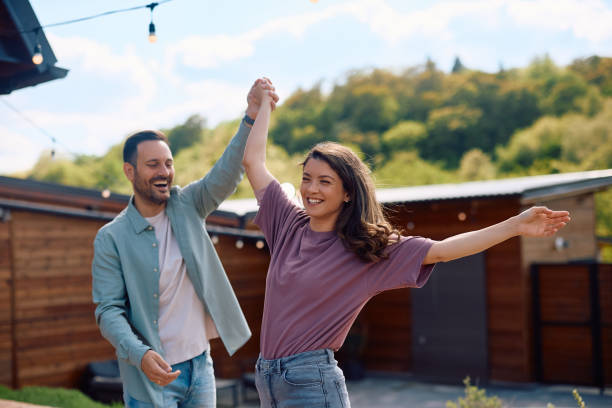 istock Carefree couple having fun while dancing in their backyard. 2153193785