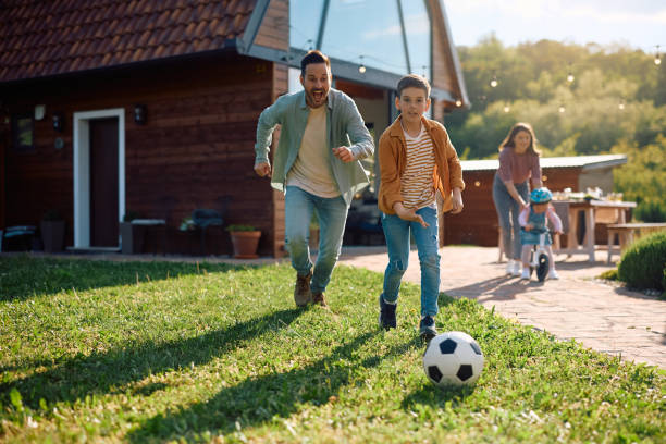 istock Happy father and son playing soccer in the backyard. 2153193959