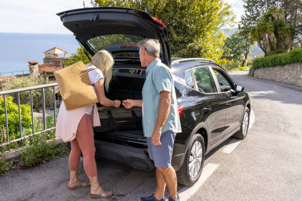 istock Mature couple remove luggage from car 2153194783