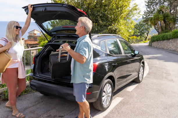 istock Mature couple remove luggage from car 2153194897
