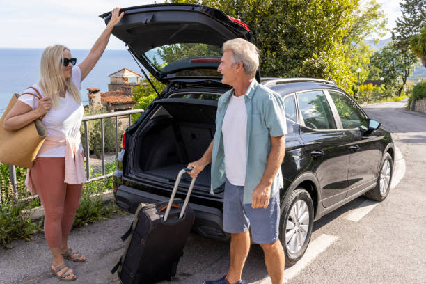 istock Mature couple remove luggage from car 2153194939