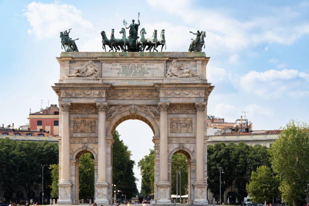 People Walking In Front Of Vittorio Emanuele II Entrance In Milan, Italy