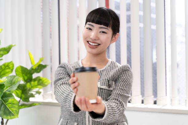 istock Female secretary handing out coffee 2153198224