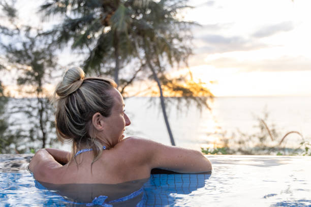 istock A Woman On Vacation, Relaxing in Infinity Pool at Sunset 2153200714