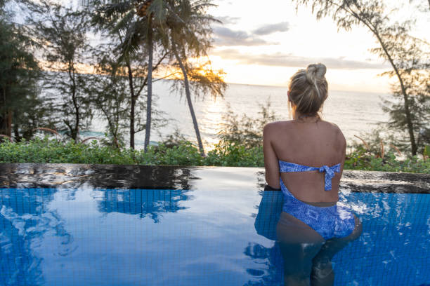 istock Woman At The Edge Of Infinity Pool at Sunset 2153200734