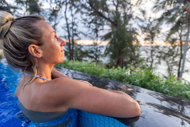 istock Woman in Infinity Pool Gazing At The Sunset 2153200736