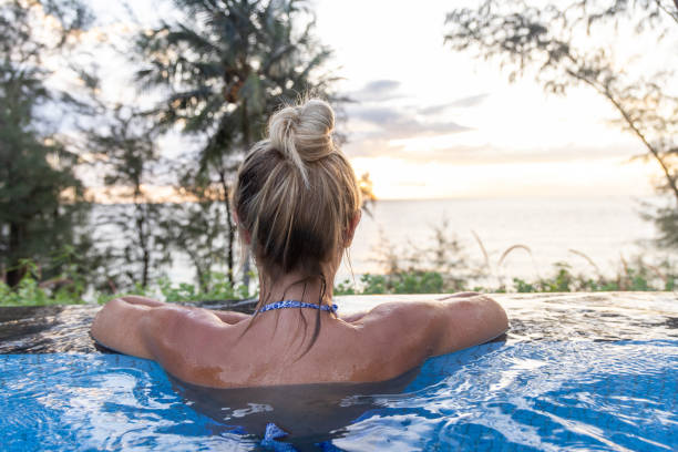 istock Rear View Of Woman At A Pool's Edge 2153200772