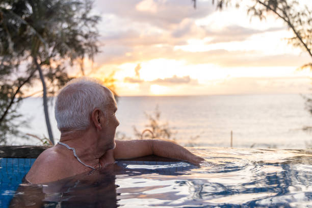 istock Senior Man Relaxing in an Infinity Pool 2153200858