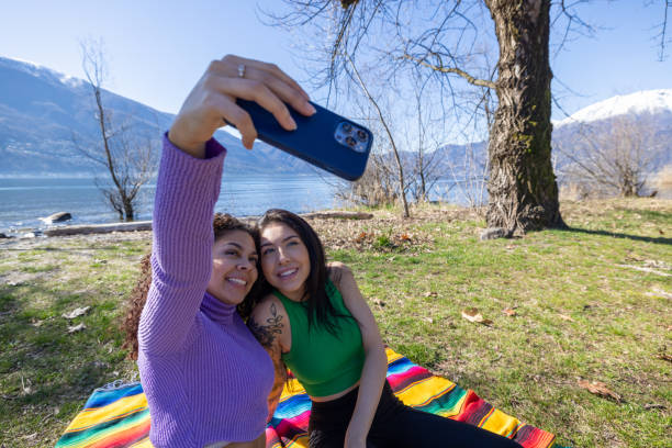 istock Spring Selfie Fun: Young Women Chatting and Smiling in the Park 2153204530