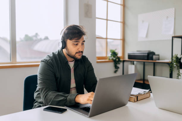 istock Young casually clothed man working at call center 2153207463