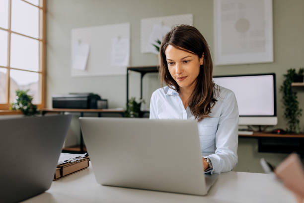 istock Young beautiful woman using laptop at the office 2153207488