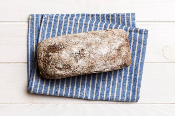 istock Fresh rye bread on napkin on rustic background, fresh bread top view 2153207759