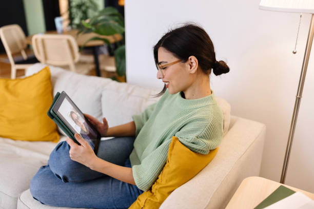 istock Lovely woman having a video call on a digital tablet 2153210012