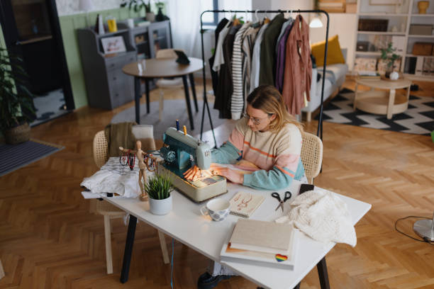 istock Lovely female sewing on a sewing machine 2153210684
