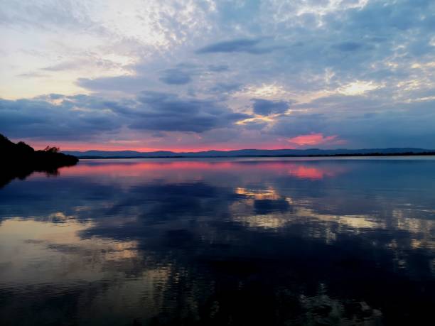 Landscapes of Scotland - Loch Leven A view across Loch Leven during sunset from Finadtie beach. beach fire scotland stock pictures, royalty-free photos & images