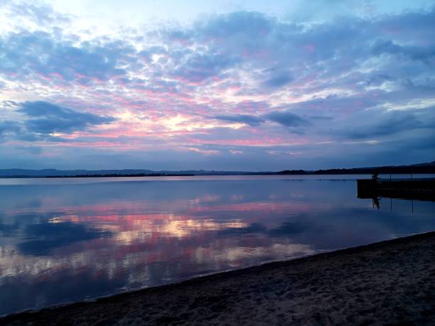 Landscapes of Scotland - Loch Leven A view across Loch Leven during sunset from Finadtie beach. beach fire scotland stock pictures, royalty-free photos & images
