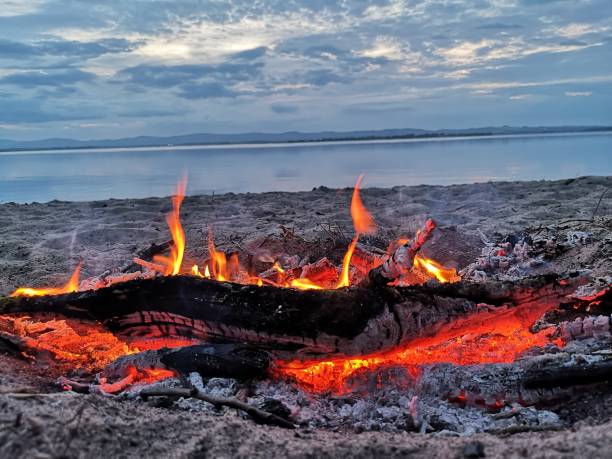 Landscapes of Scotland - Loch Leven A view across Loch Leven during sunset from Finadtie beach. beach fire scotland stock pictures, royalty-free photos & images