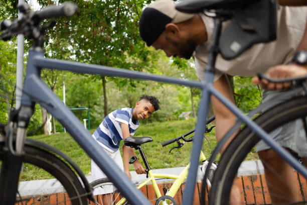 istock Latin American boy is going to ride bicycle with his dad 2153216347
