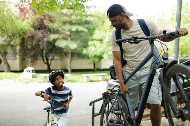 istock Cute Latin boy going for a bike ride with his dad 2153216363