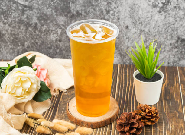 istock iced Alpine green tea with ice cube served in disposable glass isolated table side view of taiwanese drink 2153217579