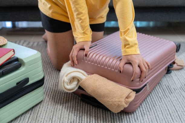 istock A young woman is packing her clothes and getting ready for a trip 2153218005