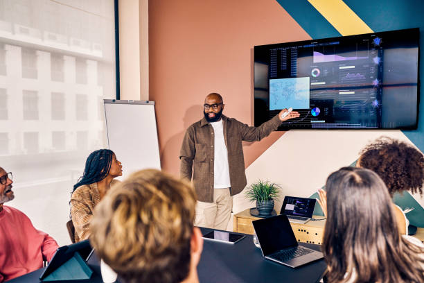 istock Multiracial business team in a meeting with data analysis presentation in a modern office. Corporate strategy and analytics concept 2153221881