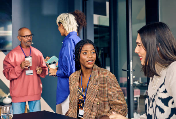 istock Gen Z co-worker discussing strategies with a colleague during a creative meeting. Multitasking and team collaboration in a diverse office environment concept. 2153221940